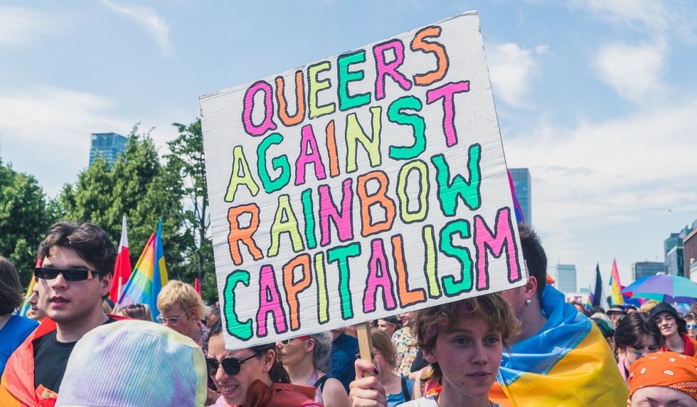 "queers against rainbow capitalism" sign
