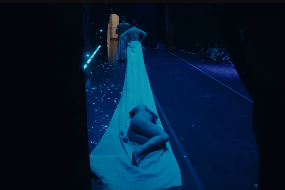Sasha Colby being dragged out on a blanket at the beginning of her show "Stripped."