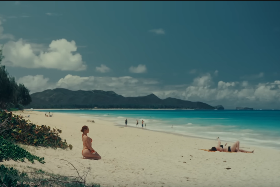 Sasha Colby knelt on the beach.