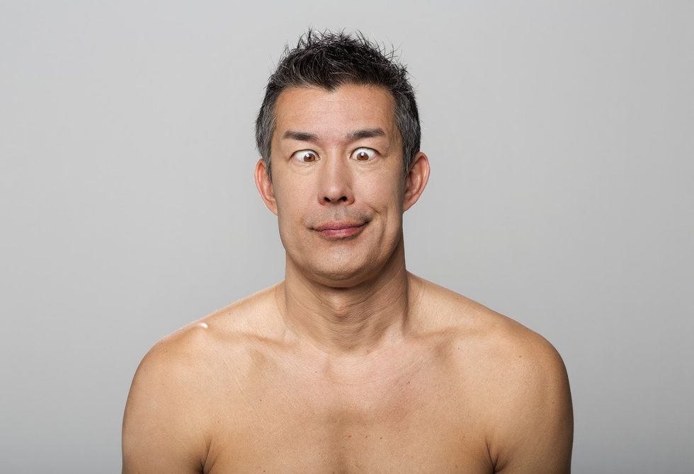 shirtless man with crossed eyes