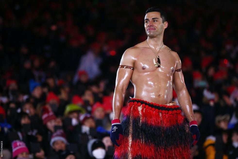 Shirtless Olympic flag bearers
