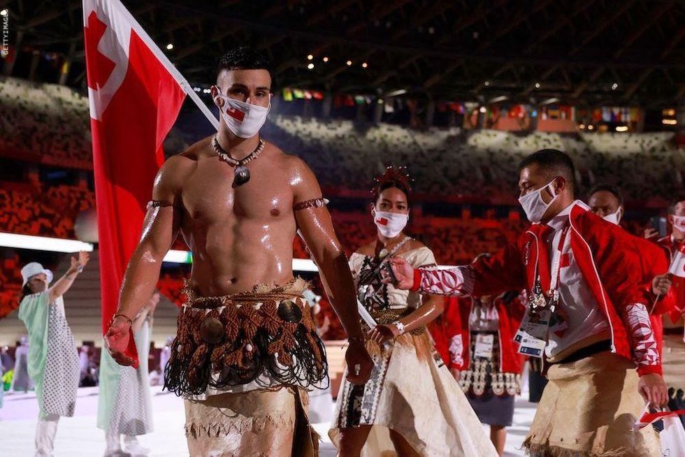 Shirtless Olympic flag bearers
