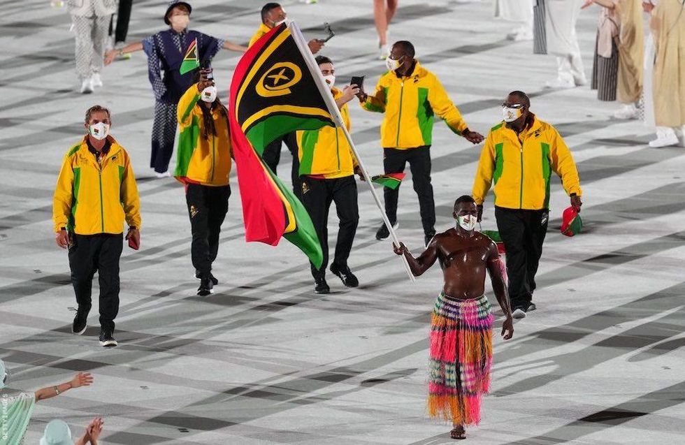 Shirtless Olympic flag bearers