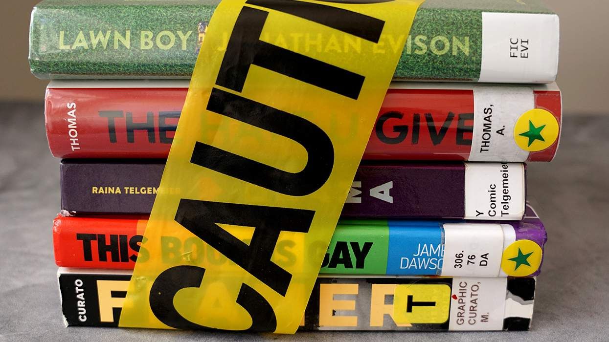stack of books found on frequently banned book lists wrapped in caution tape