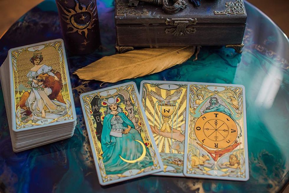 tarot deck with three cards laid out