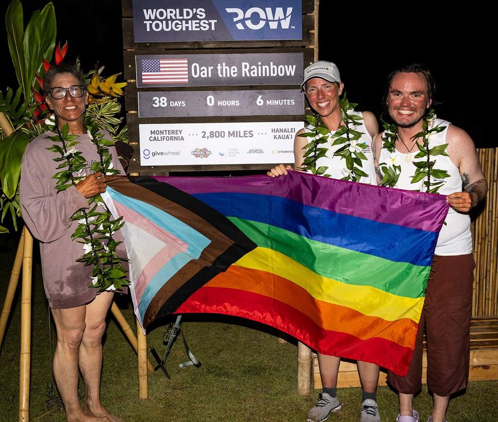 Team Oar the Rainbow OPED author pictured right holding rainbow flag