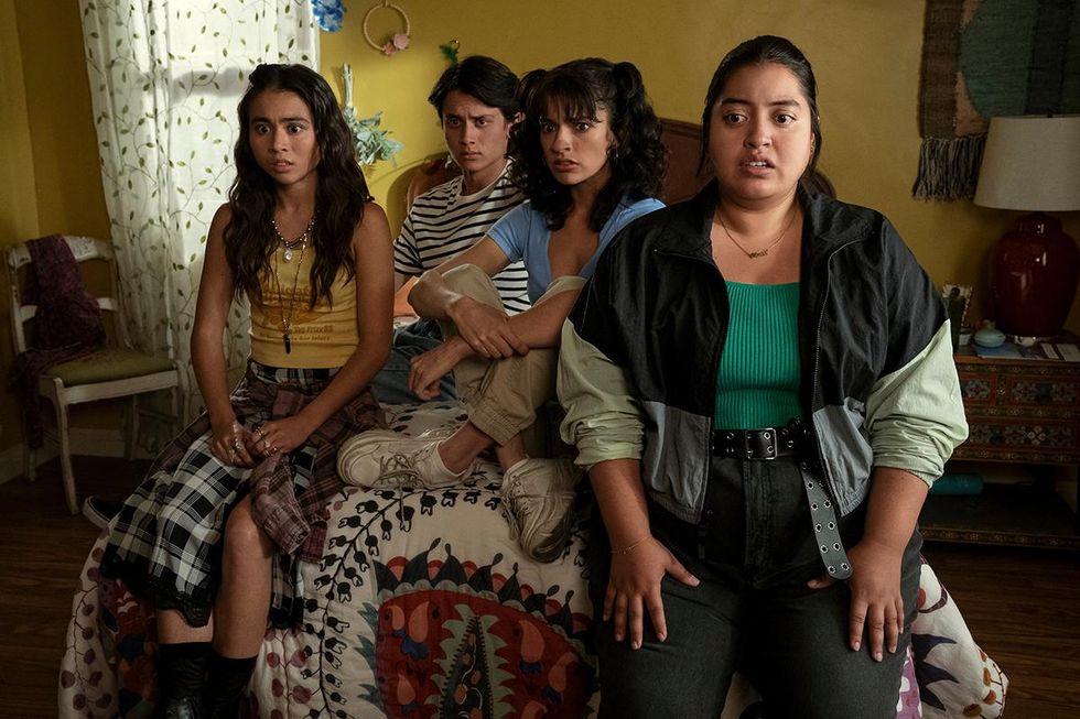 The cast of Freeridge sit on a bed