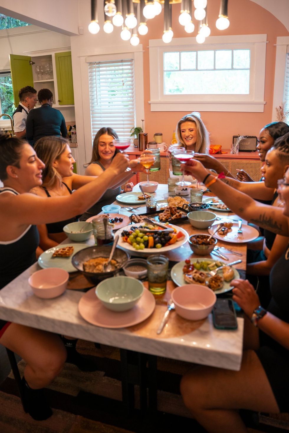 The cast share a meal behind the scenes at the TomboyX shoot