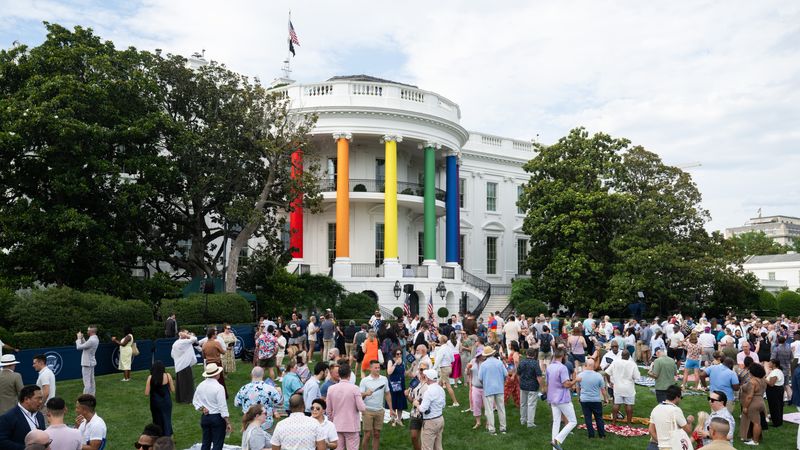 The White House with the pillars painted the colors of the rainbow flag