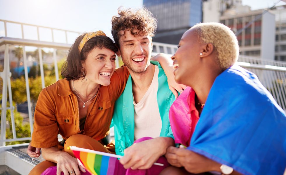 Three LGBTQ+ persons sitting outside