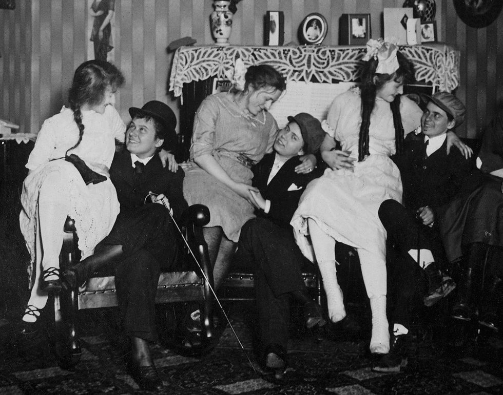 Three women couples cuddle on laps, ca. 1910