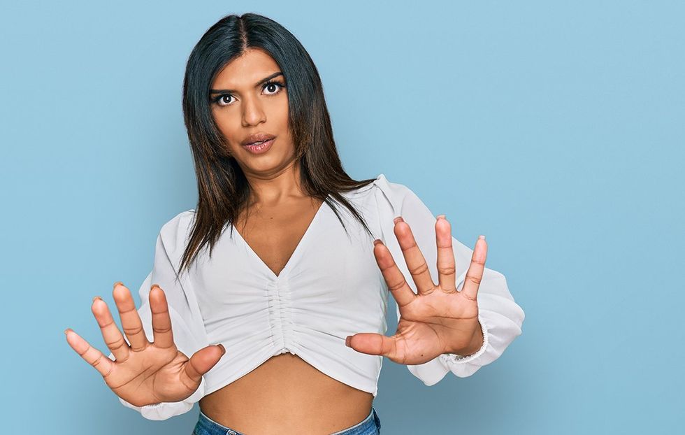 trans woman holding up hands