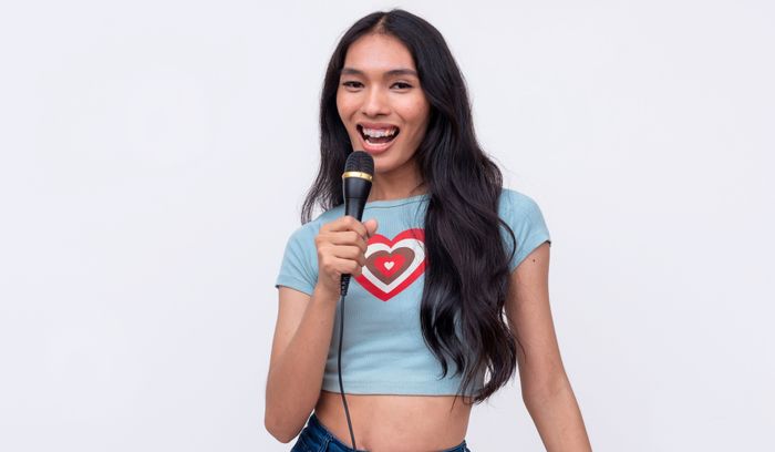 Transgender woman singing with a microphone