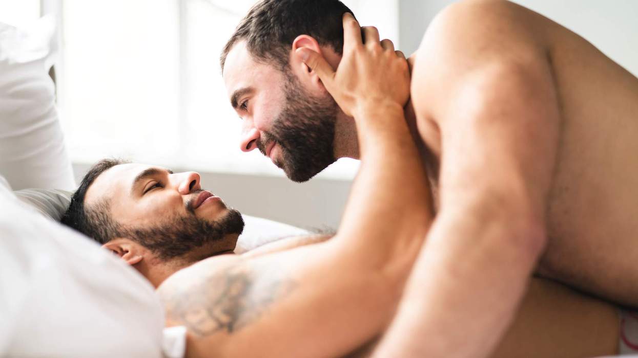 Two gay men in bed together