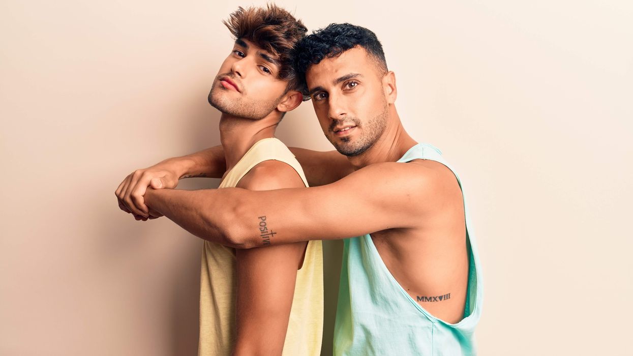 Two gay men in tank tops