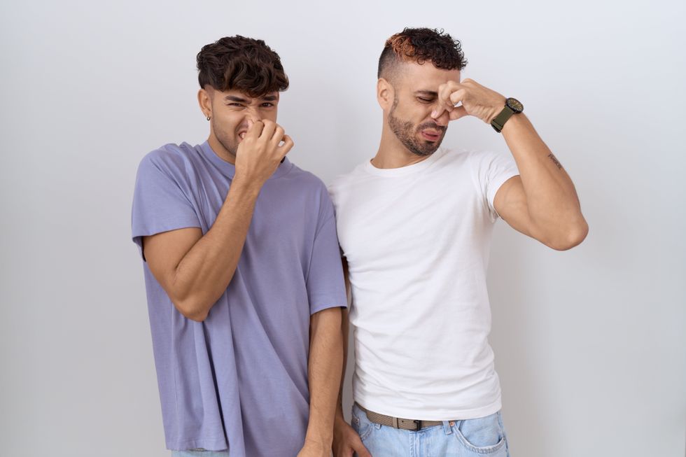 two guys pinching their noses
