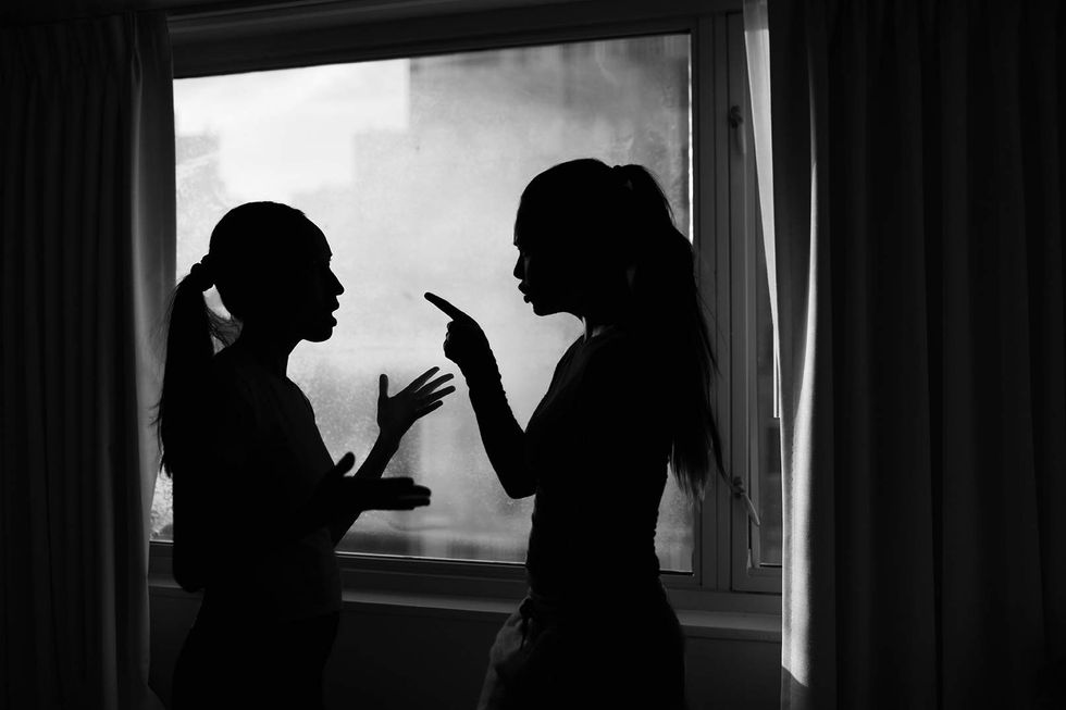 Two lesbian arguing in silhouette