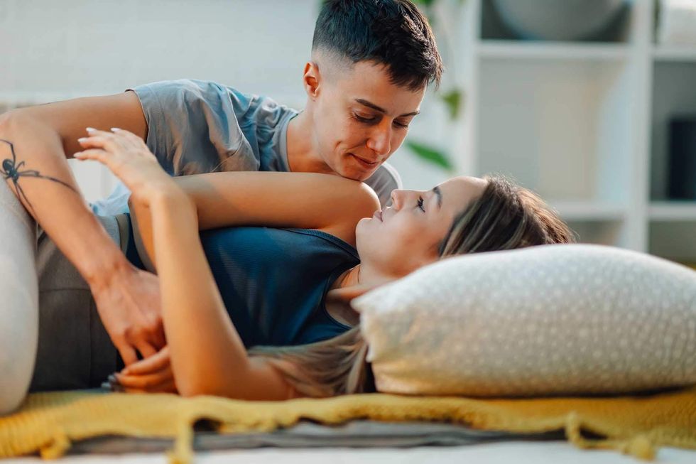 two lesbians cuddling in bed