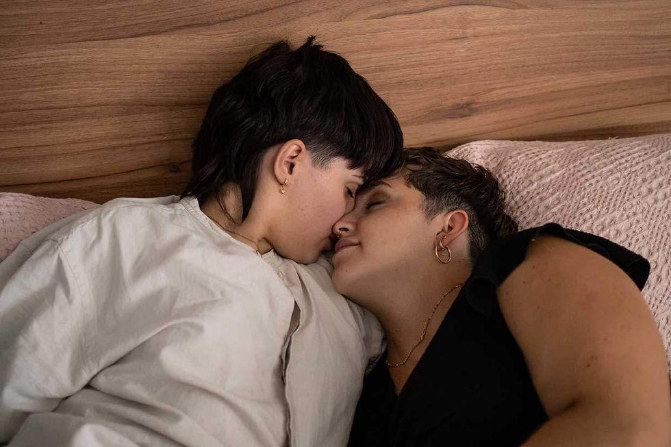 Two lesbians lying in bed together