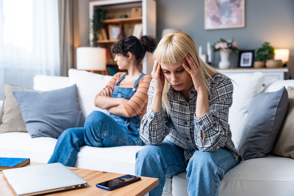 Two lesbians upset and sitting on a couch