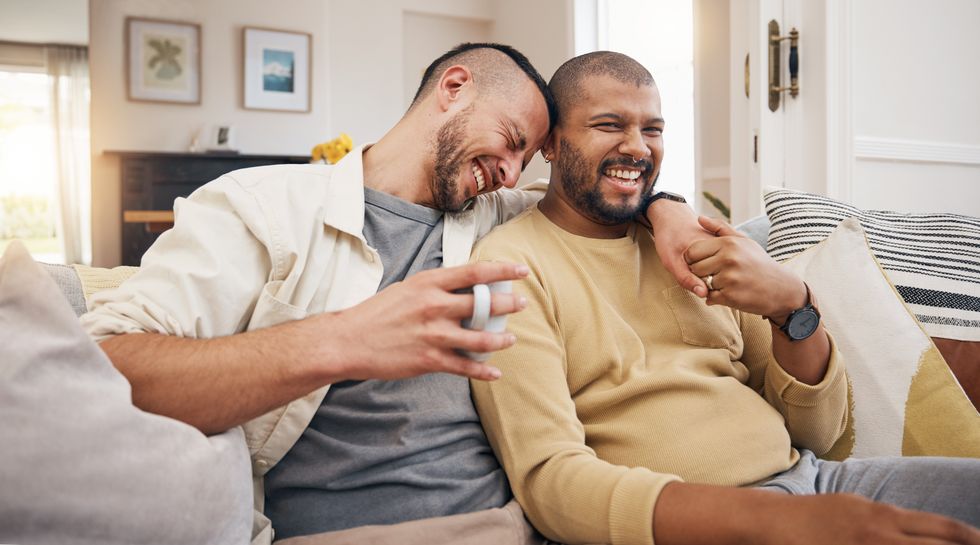 two men cuddling on the couch