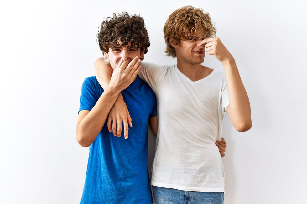 two men holding their noses