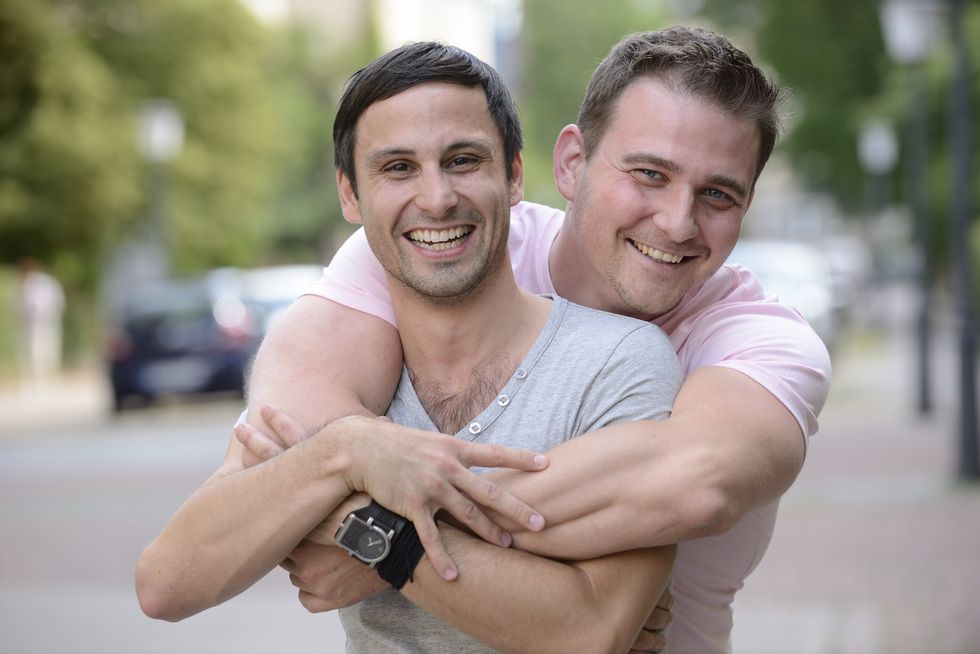 two men hugging and smiling