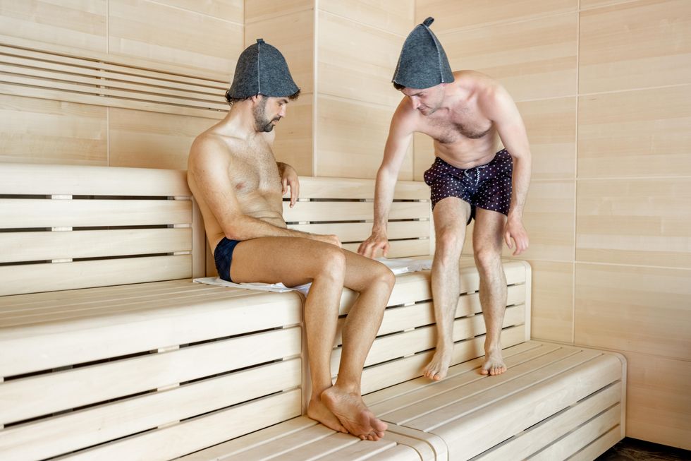 two men in hats in sauna