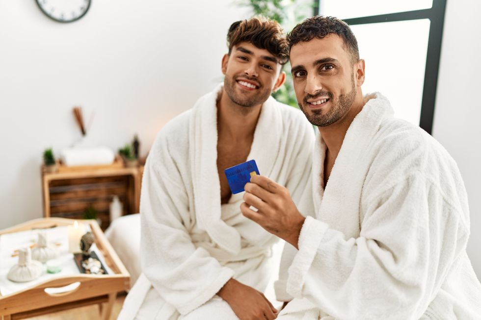 two men in robes on a bed