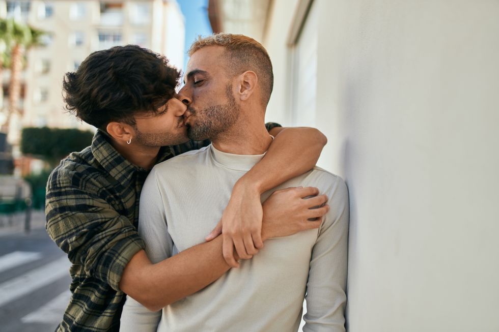 two men kissing on the street