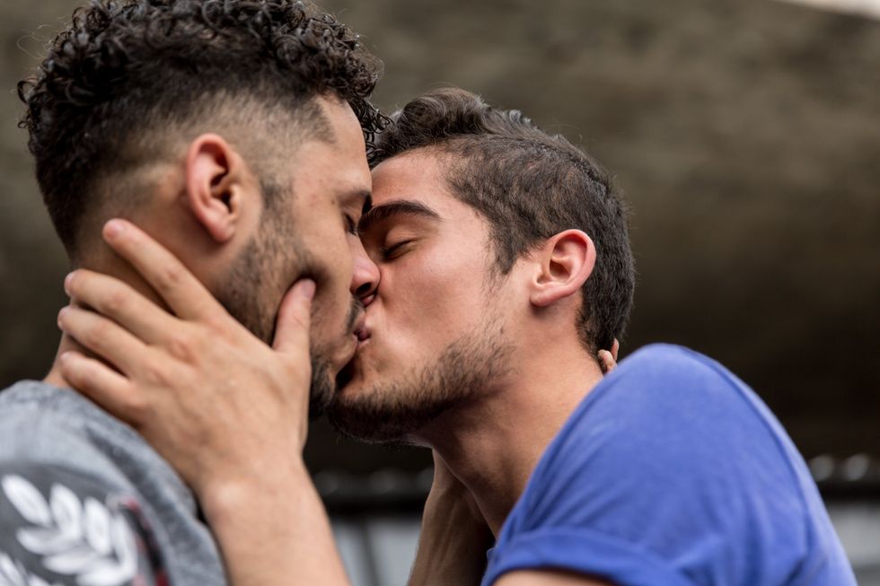 two men kissing passionately
