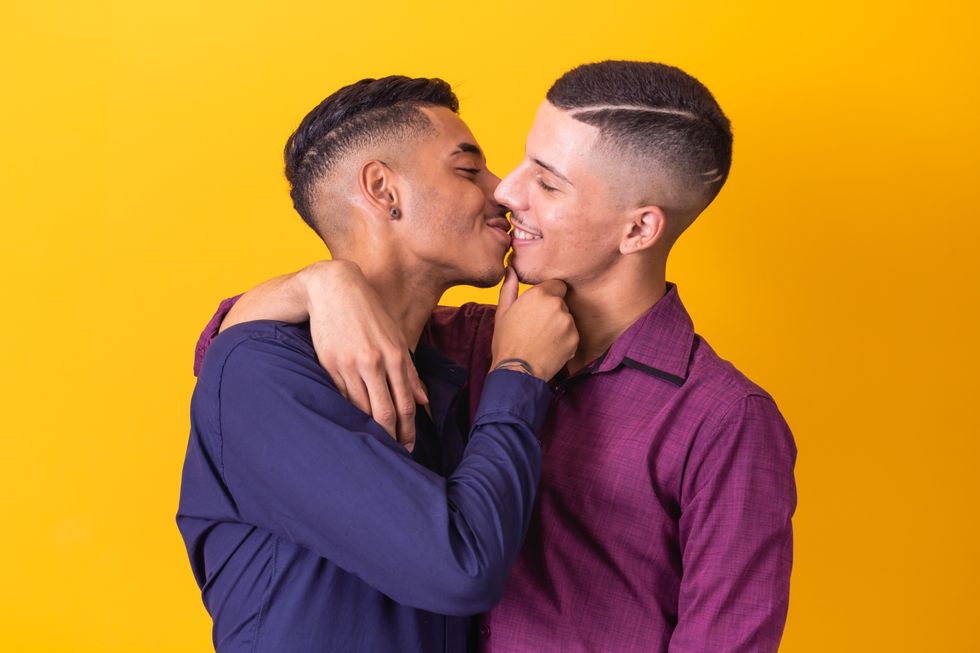 two men laughing and kissing
