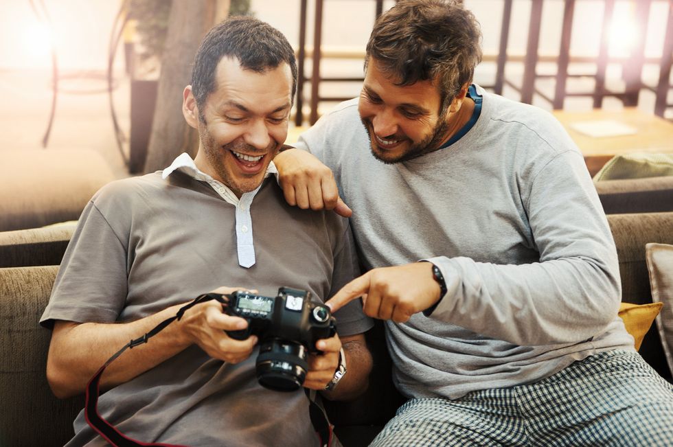 two men laughing at a camera