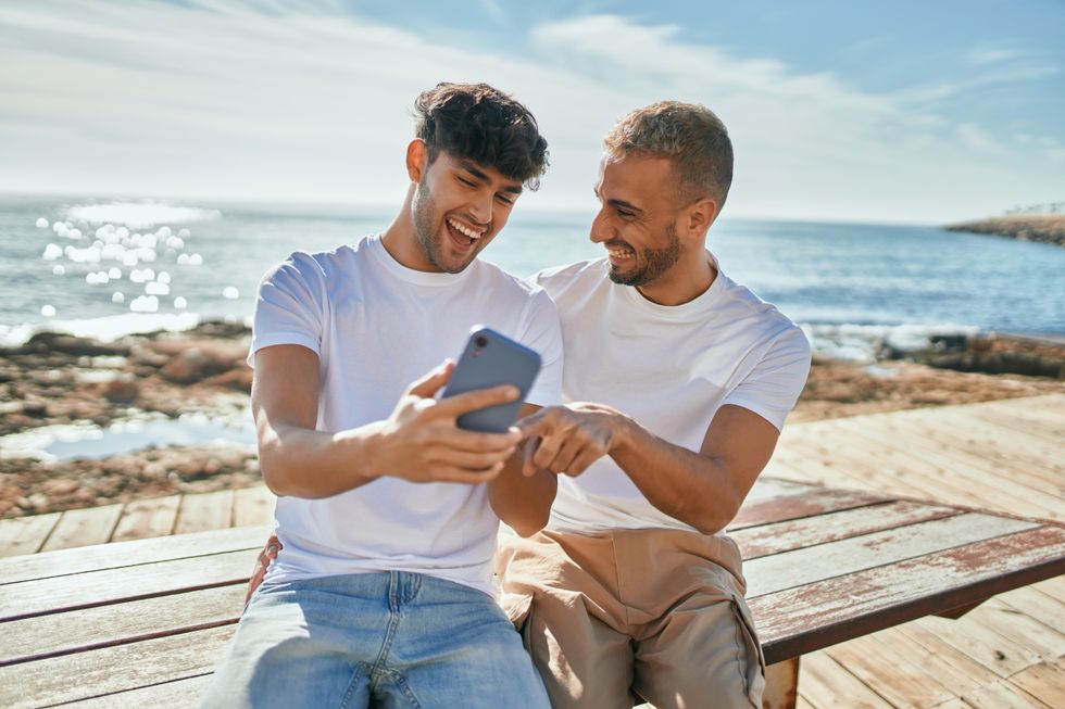 two men laughing over a text message