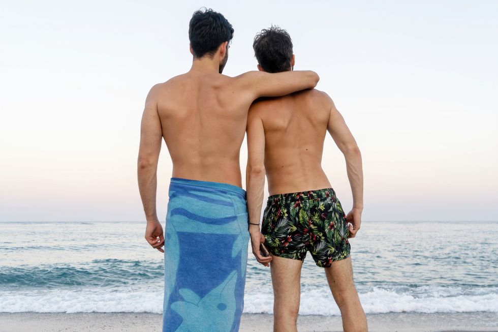 two men looking at the ocean
