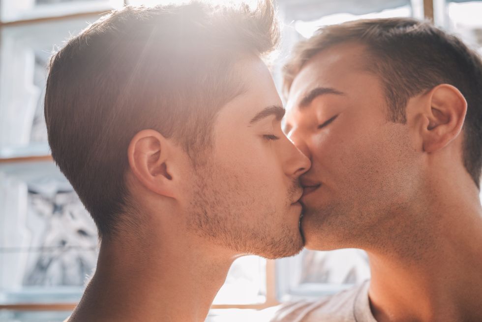 two men sharing a kiss