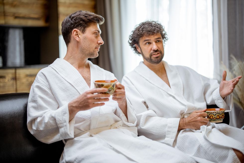 two men talking in bathrobes