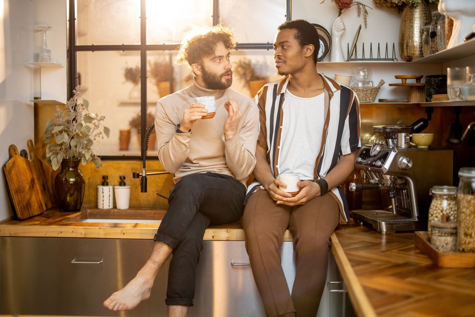 two men talking over coffee