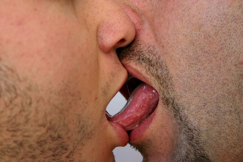 two men tongue kissing