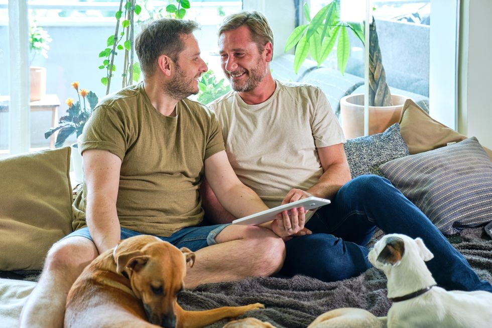 two men with their dogs