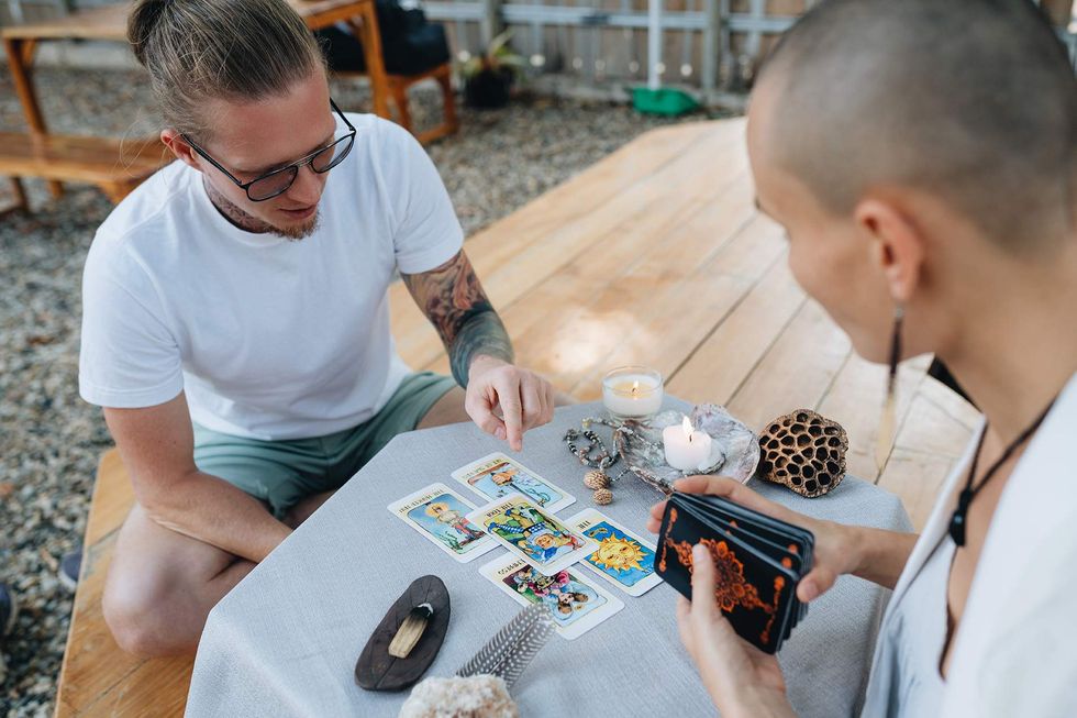 two queer people doing tarot