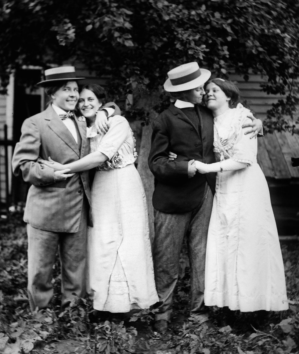 Two women couples hug for a picture, ca. 1912.