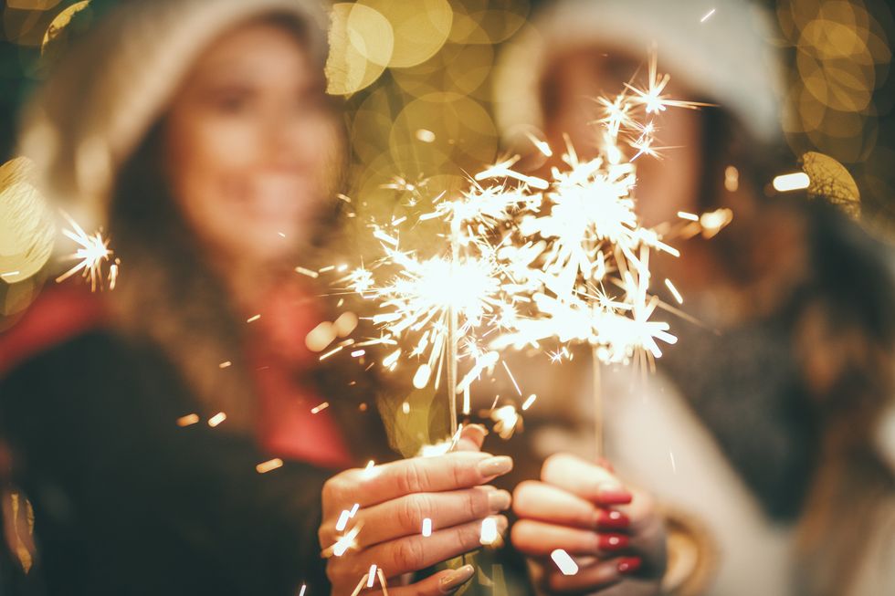 two women holding sparklers