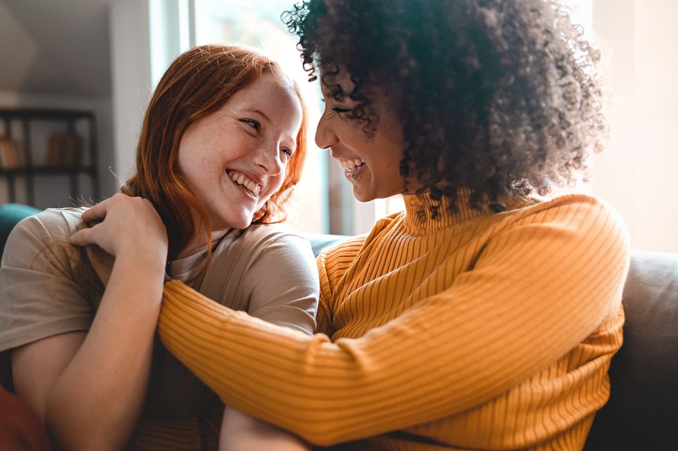 two women hugging and smiling
