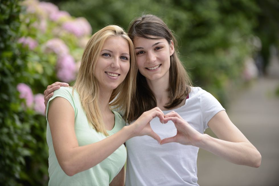 two women making a heart
