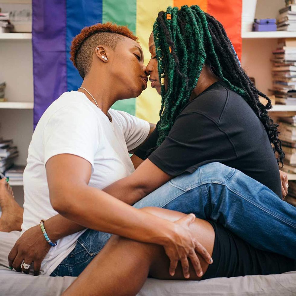 Two women scissoring while fully clothed