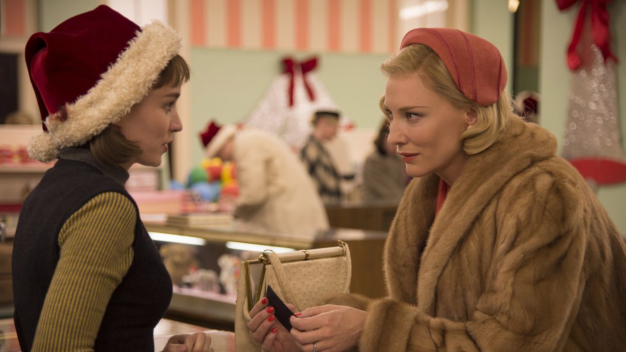 Two women talk at a department store counter in the 1950s