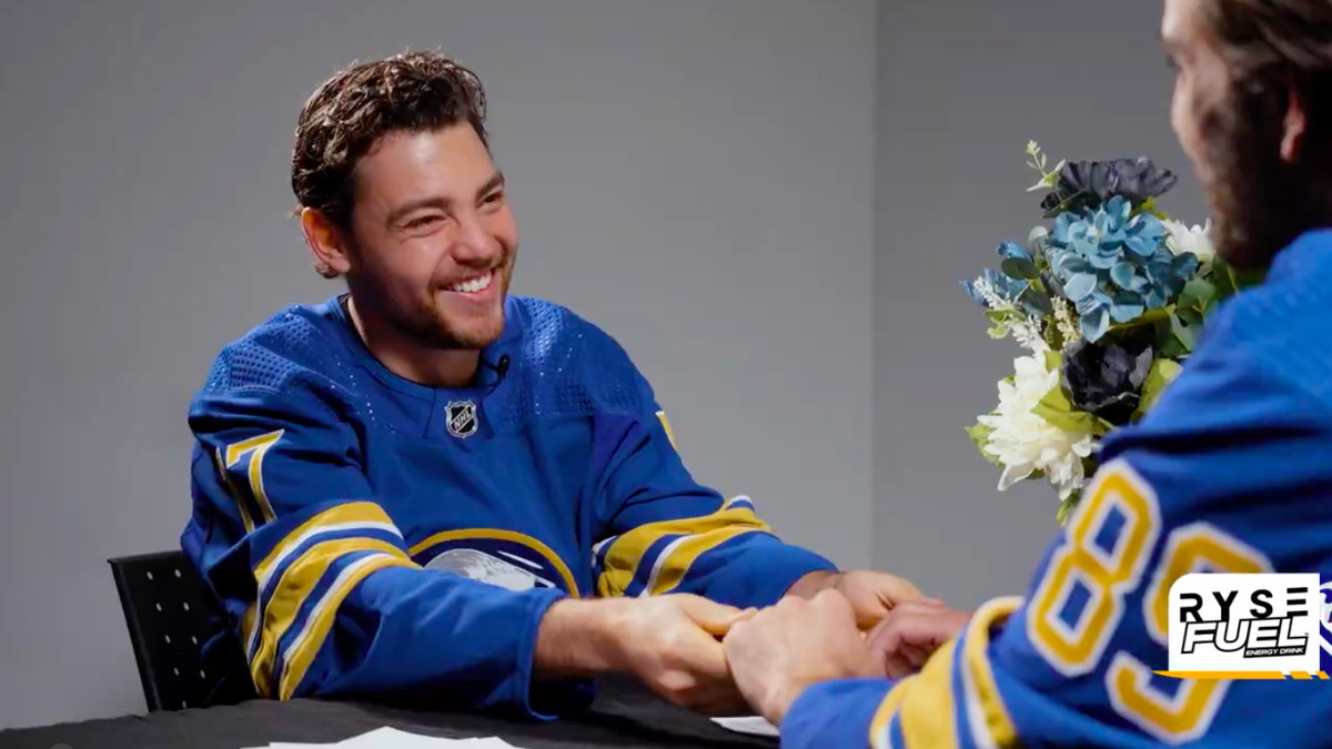 Tyson Jost and Alex Tuch holding hands in "Speed Dating" skit