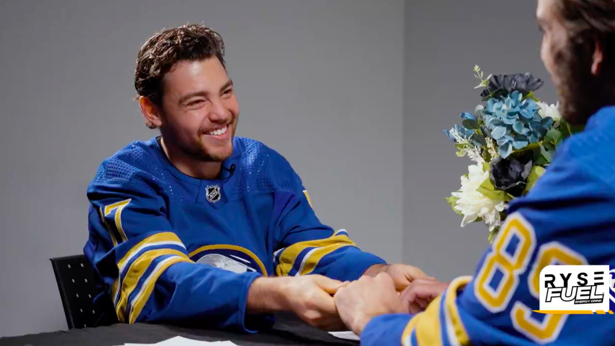 Tyson Jost and Alex Tuch holding hands in "Speed Dating" skit