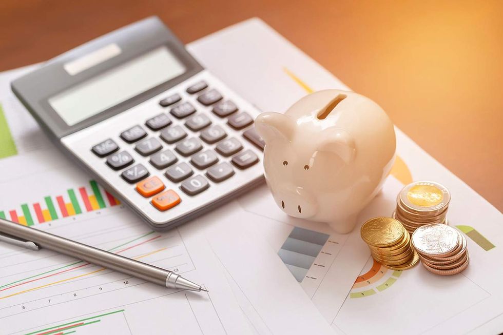 \u200bA piggy bank and calculator.